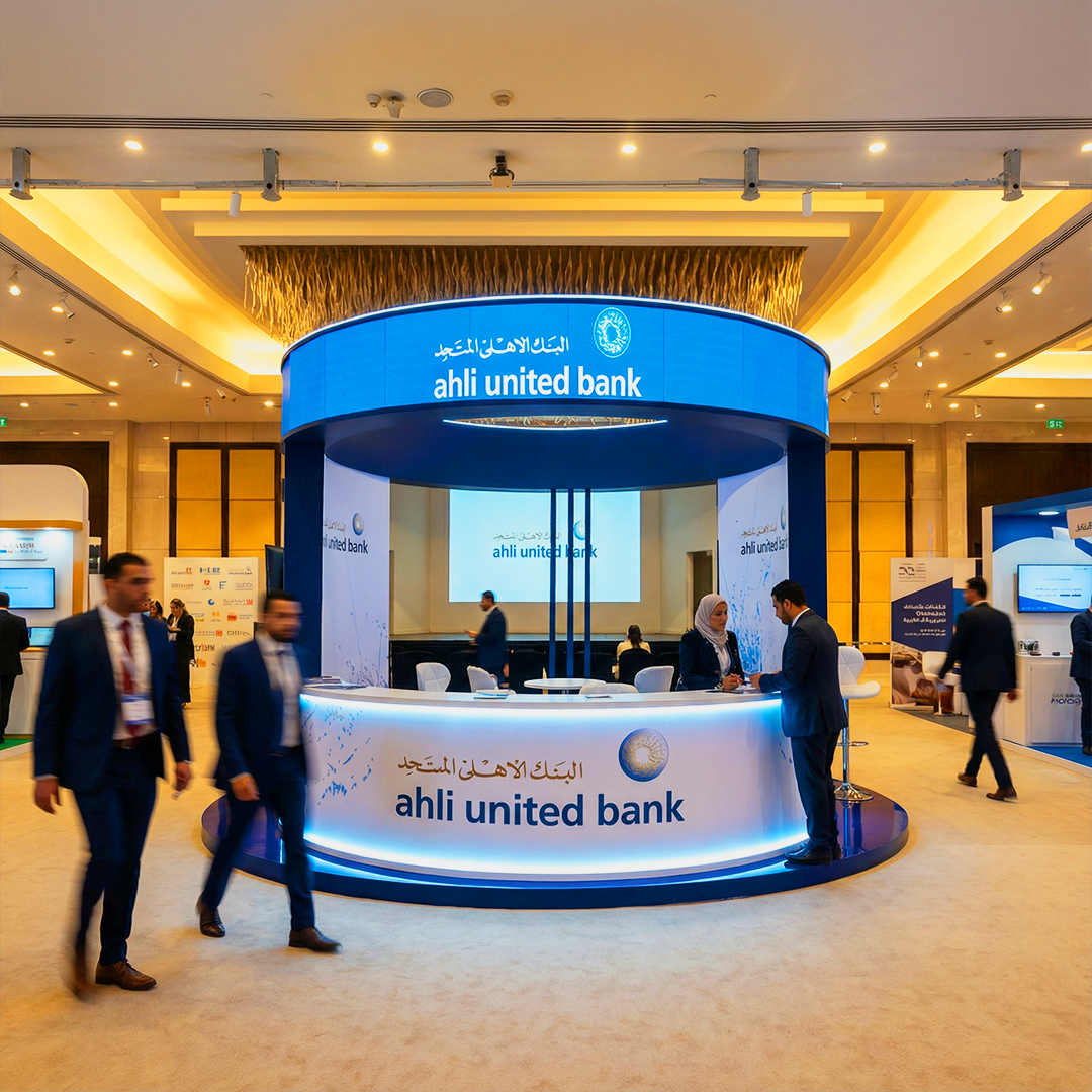 Ahli United Bank exhibition booth at a financial conference with circular design, bilingual branding, and active visitor engagement