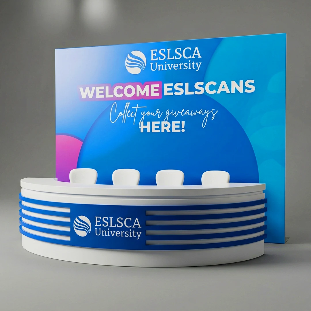 ESLSCA University welcome booth with curved counter, colorful backdrop, and seating area for giveaways